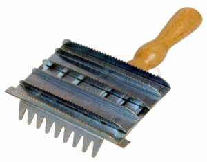 Cepillo raspador metálico. Mango de madera.